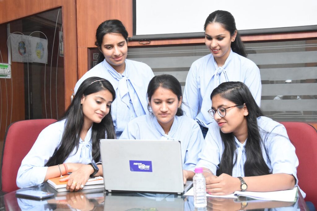pexels-photo-18067562 A group of young South Asian women working together on a laptop in a Jaipur office.
