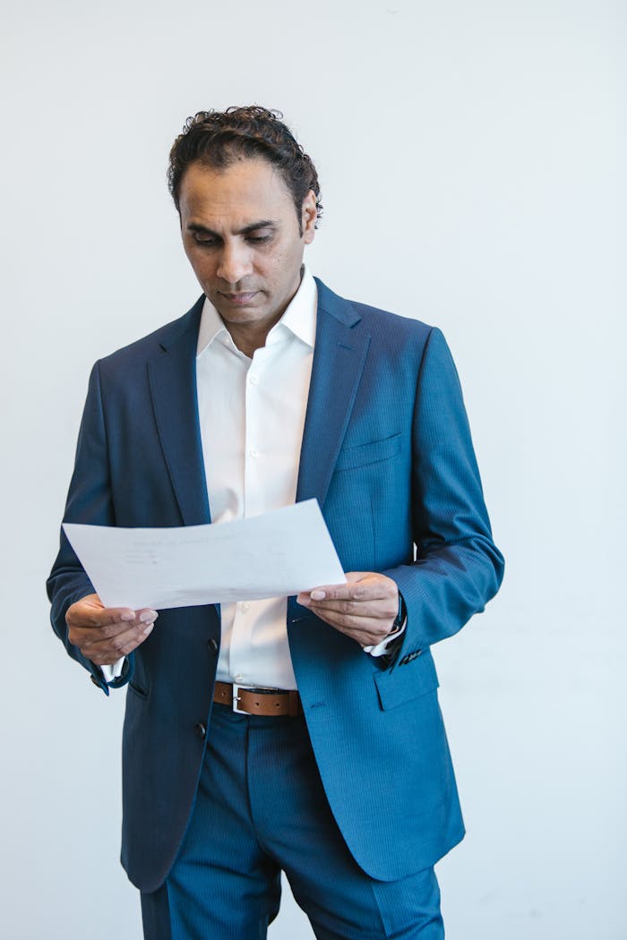 Confident businessman analyzing important documents in an office setting.